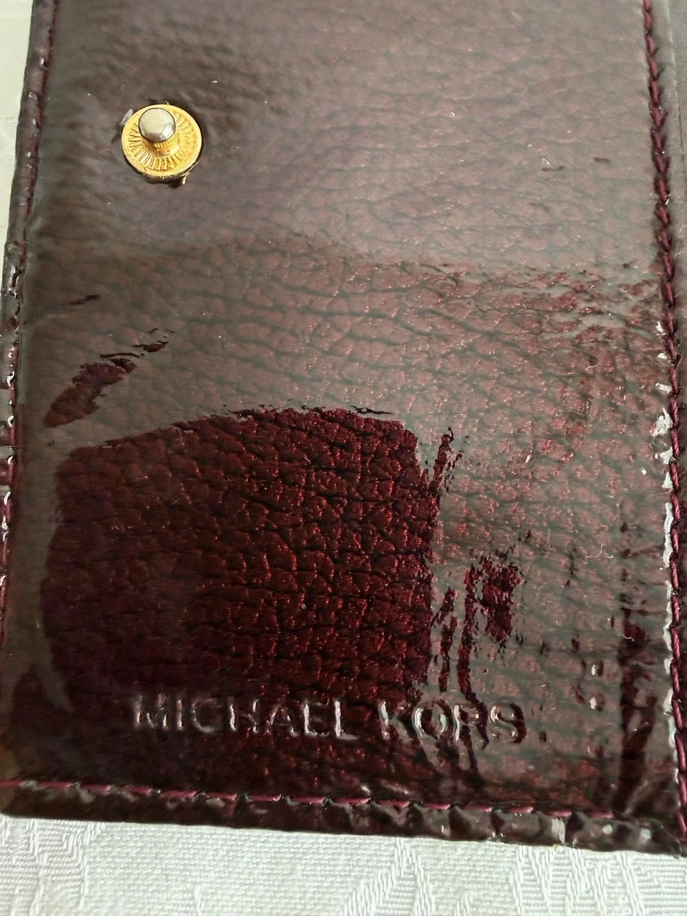 Michael Kors Burgundy patent bifold wallet with Gold Studs